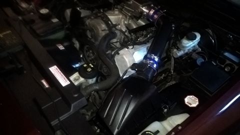 2004 Ford Crown Victoria - Engine bay view shows an aftermarket cold air intake system installed.