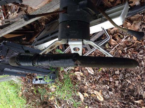 1979 Ford Bronco - Discarded steering column and other vehicle parts piled up outdoors.