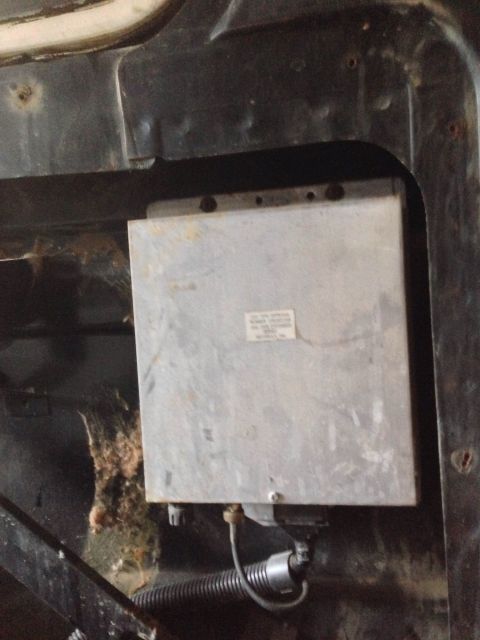 1979 Ford Bronco - Close-up of an engine control unit, likely from an older vehicle, showing some dust and debris.