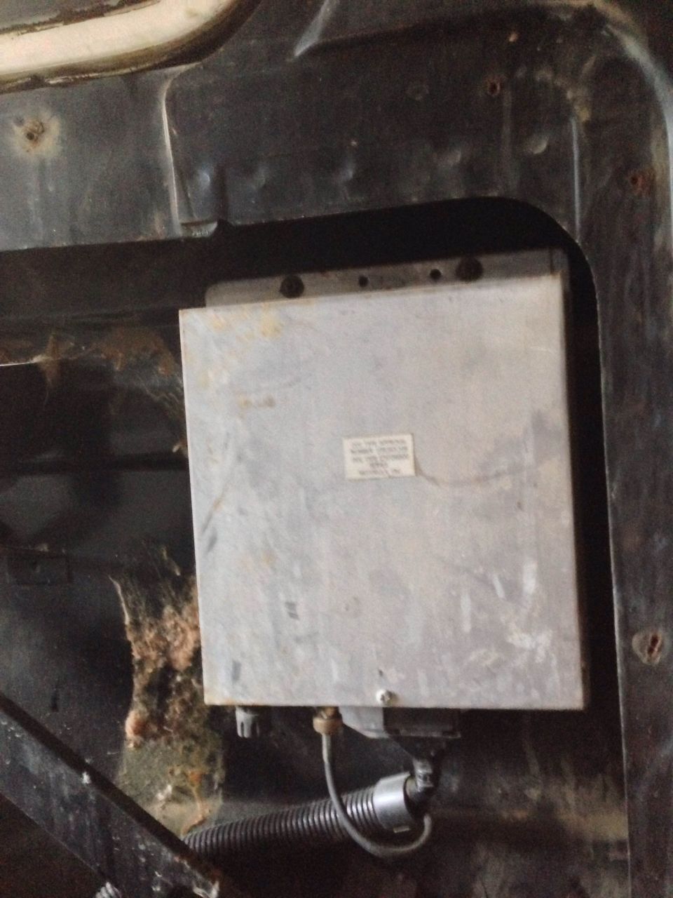 Engine control unit mounted in vehicle, with wiring harness and some debris