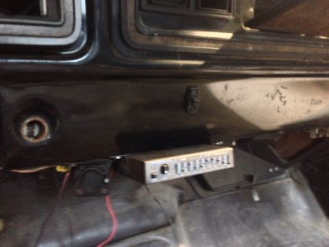 1979 Ford Bronco - An aftermarket equalizer is installed in the dashboard of this vehicle, alongside a small speaker.