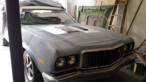 1976 Ford Ranchero - This 1976 Ford Ranchero is in primer, ready for paint, with a distinctive white stripe on the hood.