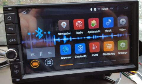 2001 Ford Excursion - A car stereo's touchscreen displays various applications and playback controls.