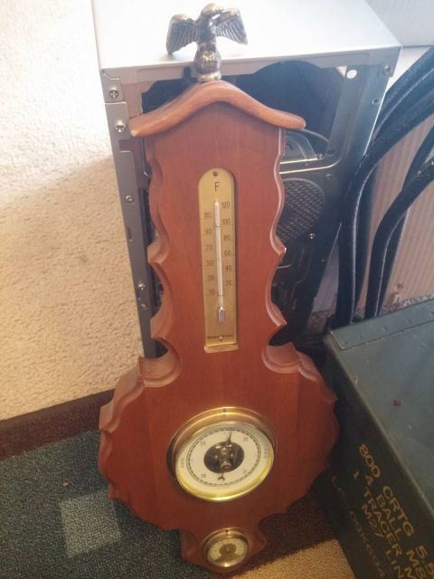 2000 Mercury Grand Marquis - A decorative wooden barometer and thermometer with an eagle figurine is displayed next to a metal ammunition box.