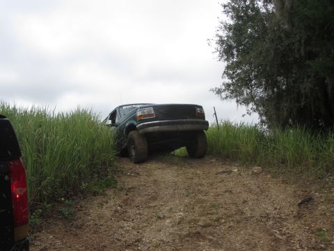 1996 Ford Bronco - 1996 Ford Bronco tackling an off-road trail with a second vehicle nearby.