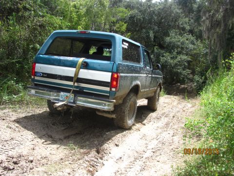 1996 Ford Bronco - This 1996 Ford Bronco is navigating a muddy, wooded trail.