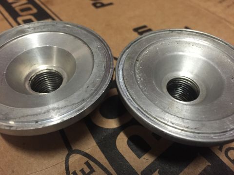 1988 Ford Bronco - Two metal components with threaded openings are shown, possibly for automotive use.