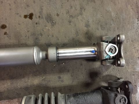 1995 Ford Bronco - Close-up of a driveshaft part with a U-joint and slip yoke.