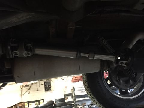1995 Ford Bronco - Underside view shows the driveshaft and exhaust system of a vehicle.