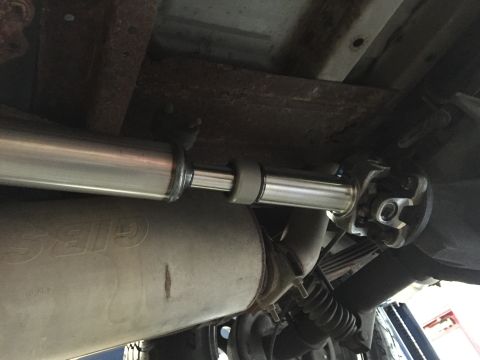 1995 Ford Bronco - Close-up of the driveshaft and exhaust components under a vehicle, indicating recent work or upgrades.