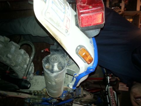 1994 Ford Bronco - Close-up view of a motorcycle's exhaust pipe and tail light assembly, with blue accents visible.