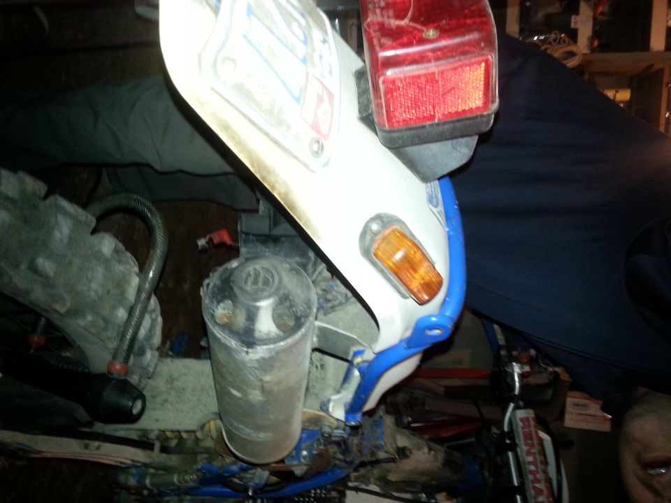 Motorcycle exhaust pipe and tail light assembly