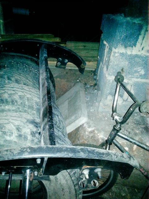 1994 Ford Bronco - Vehicle suspension parts and tires are visible, along with a bicycle frame in the background.