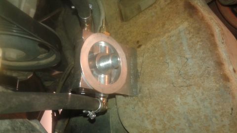 1996 Ford Bronco - Close-up of an oil filter relocation adapter with hoses, mounted in a vehicle's engine bay.