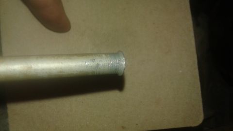 1996 Ford Bronco - A close-up view of a metal tube with a flared end.