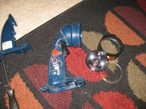 1994 Ford Bronco - A disassembled blue Ryobi flashlight lies on a patterned rug next to a screwdriver.