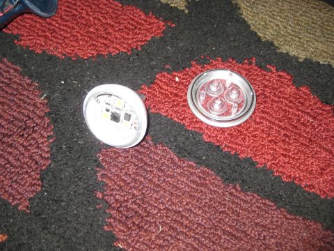1994 Ford Bronco - Disassembled LED light components are shown on a patterned carpet.