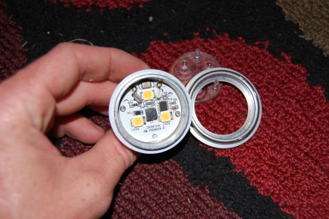 1994 Ford Bronco - A person is holding a disassembled LED light bulb, revealing the circuit board with multiple LEDs and electronic components. The light bulb…