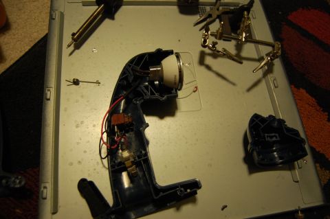 1994 Ford Bronco - Disassembled flashlight components and tools laid out on a workbench.