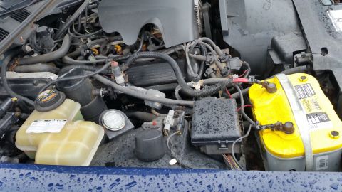 1991 Ford LTD Crown Victoria - Photograph of an engine compartment showing the wiring harness, fuse box, and battery, not a technical document.