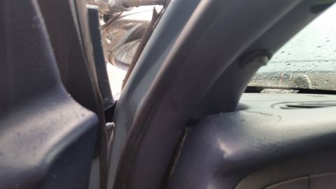 1991 Ford LTD Crown Victoria - Photo of interior A-pillar and dashboard trim, not a technical document.