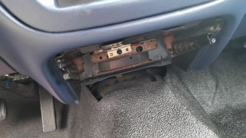 1991 Ford LTD Crown Victoria - Photo of the under-dash area with a radio bracket and pedals, not a technical document.