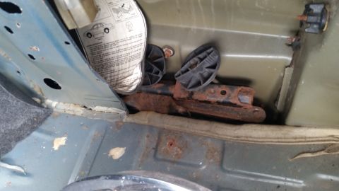 1991 Ford LTD Crown Victoria - Photo of a rusted jack and tools in the trunk, not a technical document.