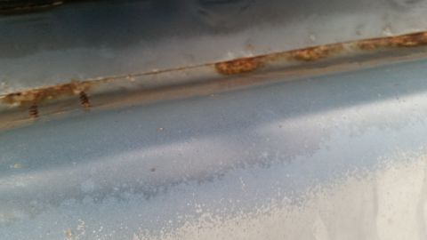 1991 Ford LTD Crown Victoria - Photo of a rusty body panel seam, not a technical document.