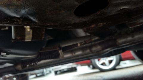 1991 Ford LTD Crown Victoria - Photo of a vehicle undercarriage with driveshaft and frame, not a technical document.