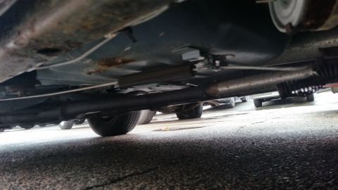 1991 Ford LTD Crown Victoria - Photo of a vehicle underbody with fuel and brake lines, not a technical document.