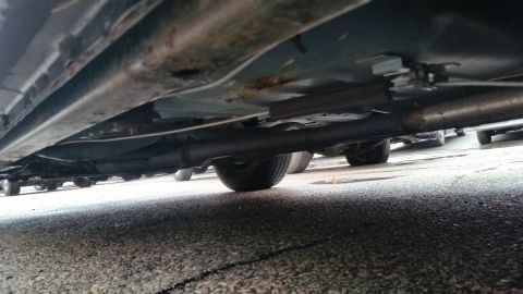1991 Ford LTD Crown Victoria - Photo of a vehicle undercarriage with exhaust pipe, not a technical document.