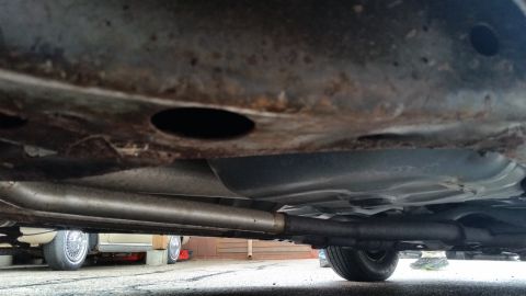 1991 Ford LTD Crown Victoria - Photo of a vehicle underbody with rusty frame and exhaust, not a technical document.