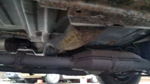 1991 Ford LTD Crown Victoria - Photo of a vehicle underbody with catalytic converter and exhaust, not a technical document.