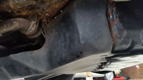 1991 Ford LTD Crown Victoria - Photo of a vehicle underbody floor pan and frame, not a technical document.