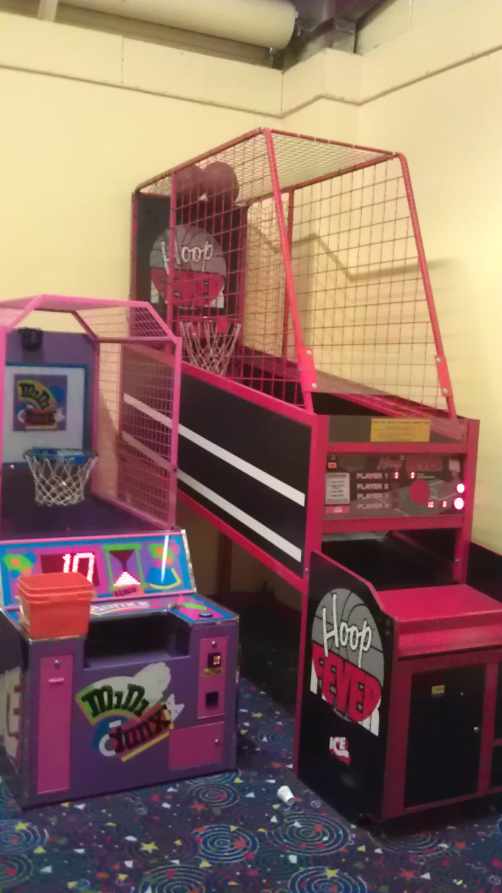 Two arcade basketball games, "Hoop Fever" and "Multi-Shot", in a room.