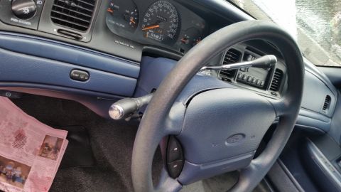 1991 Ford LTD Crown Victoria - Photo of a vehicle steering wheel and dashboard, not a technical document.