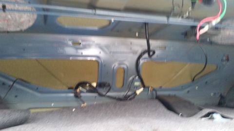 1991 Ford LTD Crown Victoria - Photograph of the inside of a trunk lid with stamped panels and a wiring harness, not a technical document.