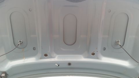 1991 Ford LTD Crown Victoria - Photograph of the underside of a body panel with stamped ribs and mounting hardware, not a diagram.