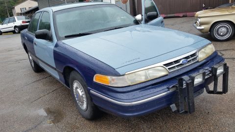 1991 Ford LTD Crown Victoria - Photograph of a two-tone blue Ford Crown Victoria from the front quarter, not a document.