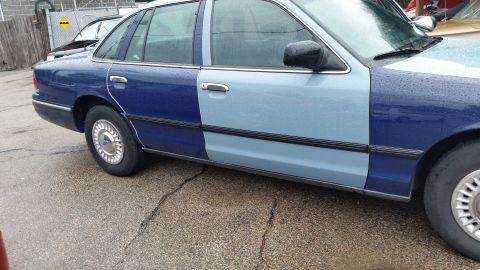 1991 Ford LTD Crown Victoria - Photo of the side doors and rocker of a two-tone blue Ford sedan, not a technical document.