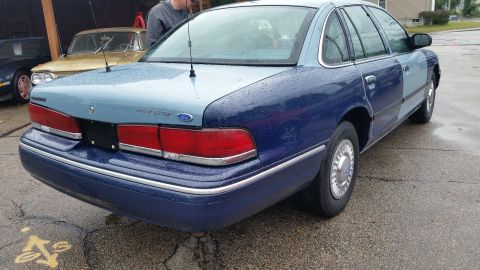 1991 Ford LTD Crown Victoria - Photograph of the rear quarter of a two-tone blue Ford/Mercury sedan, not a document.