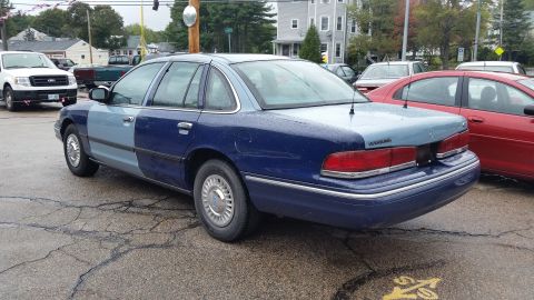 1991 Ford LTD Crown Victoria - Photograph of a two-tone blue Ford sedan from the rear quarter in a parking lot, not a document.