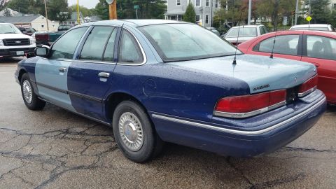 1991 Ford LTD Crown Victoria - Photo of a two-tone blue Ford Crown Victoria from the rear quarter, not a technical document.