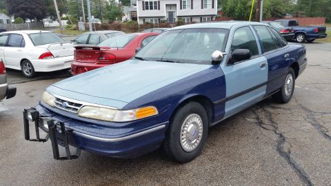 1991 Ford LTD Crown Victoria - Photograph of a two-tone blue Ford Crown Victoria from the front quarter, not a document.