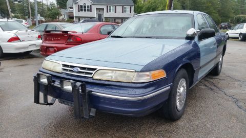 1991 Ford LTD Crown Victoria - Photo of the front of a two-tone blue Ford Crown Victoria with a push bar, not a document.
