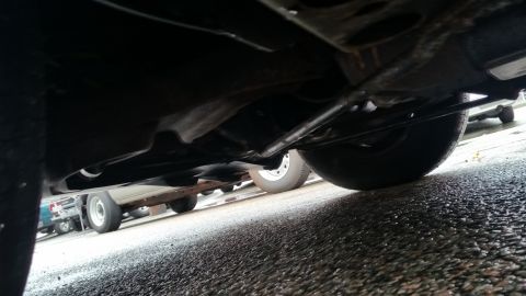 1991 Ford LTD Crown Victoria - Photograph of a vehicle's undercarriage with exhaust and suspension, not a technical diagram.