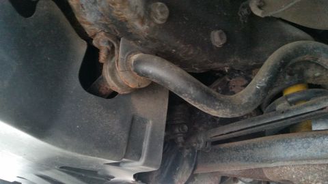 1991 Ford LTD Crown Victoria - Photograph of vehicle front suspension with sway bar and control arm, not a diagram.