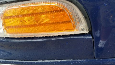 1991 Ford LTD Crown Victoria - Close-up photo of a vehicle's amber front side-marker lamp lens, not a document.