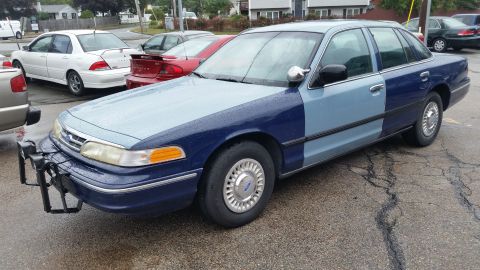 1991 Ford LTD Crown Victoria - Photograph of a two-tone blue Ford Crown Victoria from the front quarter, not a document.