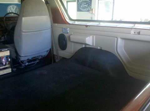 1982 Ford Bronco - The interior of an older SUV, possibly a Ford Bronco, with a visible Ford logo sign in the background.
